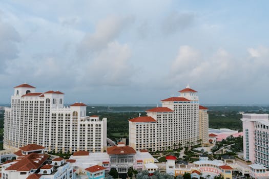 Aerial view of a luxurious resort with red roofs and modern architecture in the Bahamas.