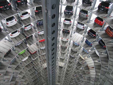 A vertical view of a spiral multi-storey car park filled with vehicles.